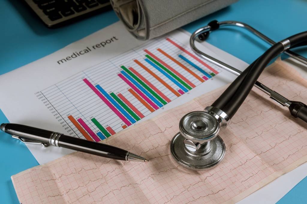 Healthcare Analytics - VLMS Healthcare The tape with the cardiogram on stethoscope and analytic diagram cardiology service